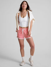 pink 2.5" inseam short with an encased elastic at waistband with drawcord, self binding at hem edges, side zipper pockets, and interior performance lining shorts.